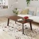 Rectangular modern wooden coffee table with rubber legs, showcasing a spacious tabletop and round edges for added.
