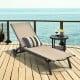 Adjustable aluminum outdoor lounge chair in brown with breathable fabric, perfect for poolside relaxation.