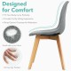 Modern dining chair with ergonomic backrest, soft sponge padding, and solid wood legs for comfort and stability.