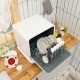 Countertop dishwasher with openable water tank, loaded with plates and cutlery, ideal for small spaces like condos or.