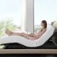 Adjustable queen size bed base with wireless remote, shown in zero gravity position for comfortable laptop use.
