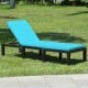 Height adjustable rattan lounge chair with blue cushion, perfect for patio or poolside relaxation.