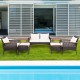 7-piece patio rattan furniture set featuring a loveseat, chairs, and tables with soft cushions for outdoor relaxation.