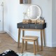 Makeup vanity table set in black with round LED mirror, four drawers, and solid wood legs for stylish dressing.