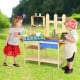 Outdoor wooden pretend cook kitchen playset for kids, made of natural fir wood with open shelves and plastic basin.