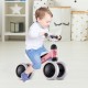 Toddler riding a pink Baby Balance Bike with 4 wheels, designed for safety and stability for kids aged 2 and up.