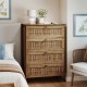 Side view of a 4-drawer dresser with oak finish and rattan-textured fronts, showcasing its modern design and metal legs.