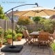 Cantilever offset patio umbrella base with realistic wood-grain finish, designed for stability and easy filling.