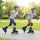 Two kids skating on 4-size adjustable light-up inline skates with LED wheels in a park, promoting balance and.