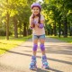 Adjustable kids roller skates in purple with light-up wheels, featuring safety gear and a fun design for outdoor play.