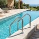 Stainless steel 4-step inground pool ladder with curved handrails and anti-skid steps for safety and stability.