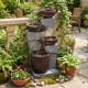 Four-tier cascading bowl outdoor water fountain with LED lights, featuring a rustic brown finish and realistic stone.