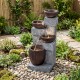 4-tier cascading bowl outdoor water fountain with LED lights, featuring rustic brown bowls and gray stone design for.