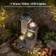 4-tier outdoor water fountain with LED lights, showcasing cascading bowls and a peaceful ambiance for relaxation.