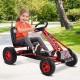 Child enjoying the red pedal-powered go-kart on a pathway, featuring four wheels and a comfortable adjustable seat.