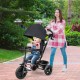 4-in-1 baby tricycle in black with adjustable canopy, reversible seat, and 5-point safety harness for versatile use.