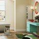 Tall storage cabinet and shower bench in a modern bathroom, featuring elegant design and multiple storage options.