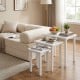 Stackable white side tables with sturdy wood tops beside a convertible sofa bed in a cozy living room setting.