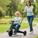 Toddler riding the 4-in-1 foldable tricycle with push handle in a park, featuring adjustable seat and EVA foam wheels.