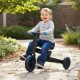 Toddler riding the 4-in-1 foldable tricycle with adjustable seat and push handle, perfect for outdoor fun and safety.