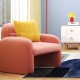 Pink velvet accent chair with armrests and waist pillow, perfect for adding charm to modern bedroom decor.