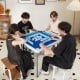 Four players enjoying a game at the 35-inch navy folding mahjong table with cup holders, featuring a smooth felt.