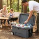 Portable 52 quart hard cooler in gray with wheels, ideal for camping and picnics, featuring 6-day ice retention.