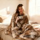 Luxurious 540GSM faux raccoon fur blanket draped over a bed, offering warmth and style for cozy moments.