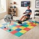 Multicolor EVA foam floor tiles provide non-slip cushioning for home gym workouts, ensuring comfort and joint protection.