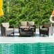 4-piece patio rattan furniture set with cushions, featuring a coffee table, ideal for poolside relaxation.
