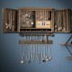 Vintage wood wall-mounted jewelry organizer with barn doors, featuring hooks and mesh for earrings, ideal for home.