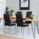 Black PVC leather dining side chairs with painted steel legs, arranged around a modern wooden table in a stylish.