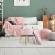 Round pink velvet storage ottoman with metal legs, ideal for footrest or stylish storage in modern living spaces.