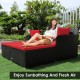Spacious outdoor rattan daybed with red upholstered cushions, perfect for sunbathing and relaxation in your garden.