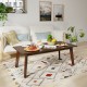 Rectangular modern wooden coffee table with rubber legs, displayed in a cozy living room setting, perfect for casual.