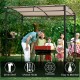 Grill gazebo with beige canopy, featuring a powder-coated steel frame and storage shelf, ideal for outdoor BBQs and.
