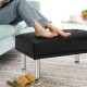 Black tufted ottoman with stainless steel legs, perfect as a footrest or shoe bench in living room or bedroom.