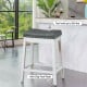 Nailhead saddle bar stool with soft upholstery, rubber wood legs, and anti-slip foot pads, ideal for kitchens and bars.
