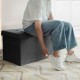 Foldable dark gray storage ottoman with padded seat, perfect for storing clothes and blankets in any room.