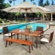 Rectangular acacia wood dining table with umbrella hole, set in a patio by the pool, ideal for outdoor gatherings.