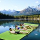 Floating water pad in green, 12’ x 6’, made of durable XPE foam, perfect for relaxing on lakes or beaches with friends.