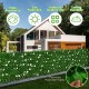 Expandable faux ivy privacy screen fence panel with white flowers, made of fade-resistant polyester fabric for outdoor.