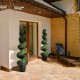 Artificial boxwood spiral tree, 4 feet tall, with green leaves in a cement base, ideal for indoor and outdoor.