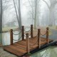 Wooden garden bridge with chain railings, stained finish, perfect for outdoor pathways and enhancing rustic decor.