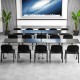 Conference room setup featuring five black office chairs with metal frames and padded cushions for ergonomic support.