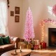 Pink 5-foot artificial Christmas tree with 328 branch tips, set up in a cozy living room for festive holiday decor.