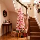 5-foot pink artificial Christmas tree with 328 branch tips, set up with gifts, perfect for holiday decor in small.