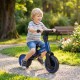 Toddler riding a blue 5-in-1 balance bike with removable pedals in a sunny park, designed for comfort and safety.