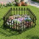 Decorative metal garden fence with fleur-de-lis finials, ideal for protecting flower beds and enhancing outdoor aesthetics.