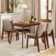 Light brown kitchen table with a smooth surface, complemented by four upholstered chairs, ideal for cozy dining experiences.